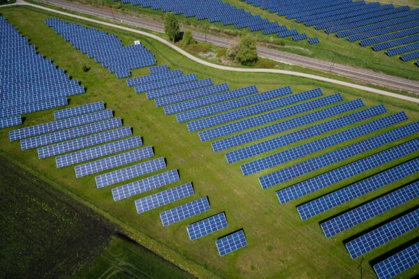 aerial photography of grass field with blue solar panels